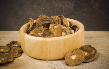 Dried forest mushrooms on a wooden table.