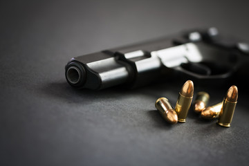 Handgun with ammunition on black background - obrazy, fototapety, plakaty