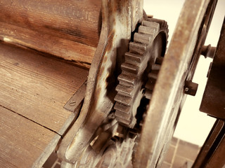 Antique clothes dryer. Old machinery details closeup. Rusty gear wheels.