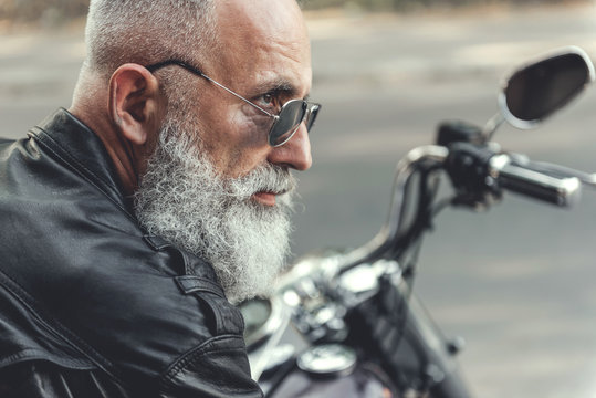 Concentrated Old Man At Motorbike