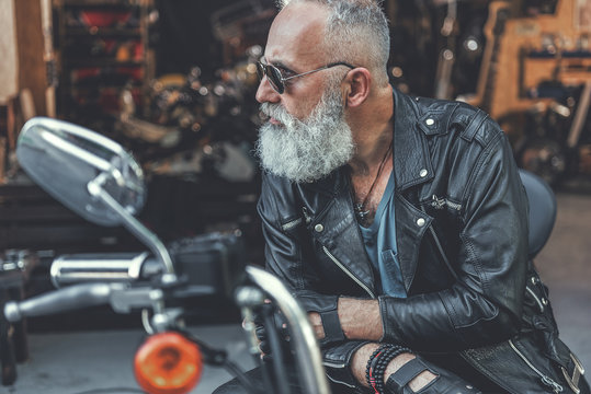 Stern Old Man Ready For Using Motorbike