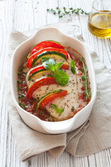 Baked chicken breast stuffed tomatoes and basil