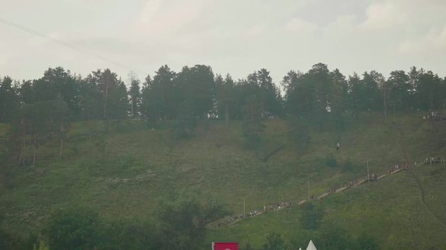 Man riding zip line in mountains at height of several metres