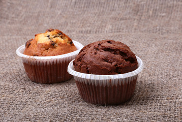 Fresh homemade muffins on Sackcloth woven texture background. Top view.