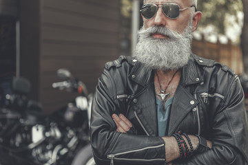 Obraz premium Assured aged man locating near motorbike