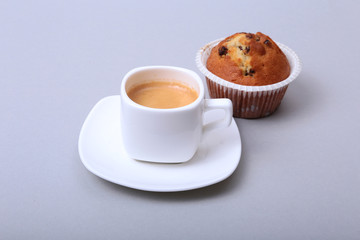 Classic espresso in white cup with homemade cake and chocolate on white background.