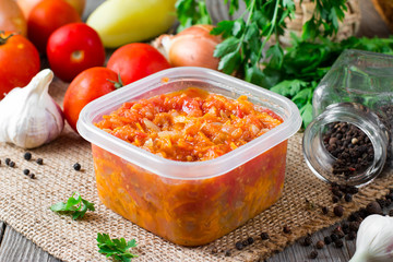 Stewed carrots and onions in a plastic container