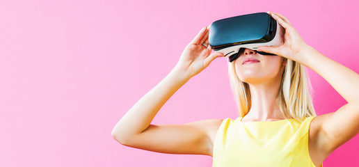 Happy young woman using a virtual reality headset