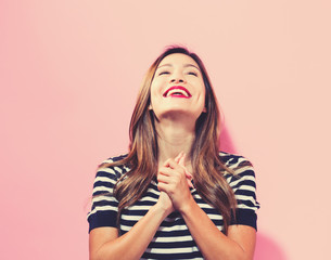 Successful young woman on a pink background