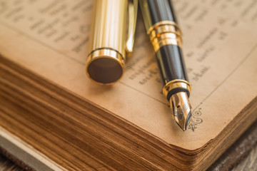 Ink pen on an old book