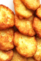 Tasty potato pancakes on white plate, closeup