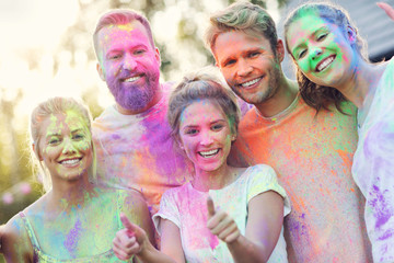 Group of friends having fun at color festival