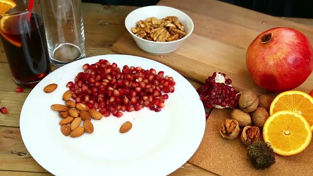 A woman with her own hands puts walnuts on a plate. Hd shot with dolly .The camera moves from right to left..