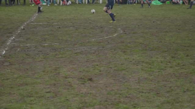 Legs of male soccer amateurs playing soccer in mountains. Part of festival