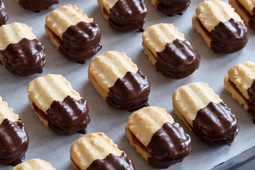 Christmas cookies filled with jam and dipped in chocolate