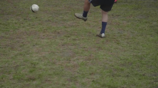 Legs of male soccer amateurs playing soccer in mountains. Part of festival