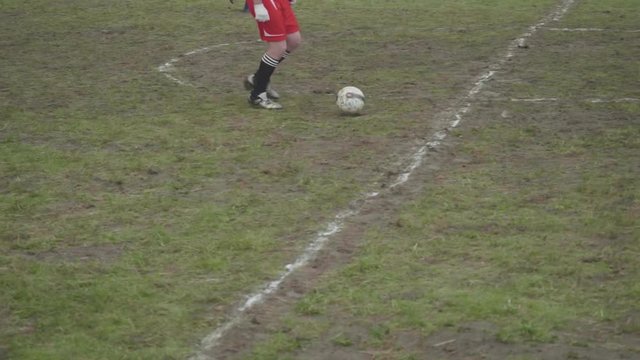 Legs of male soccer amateurs playing soccer in mountains. Part of festival
