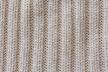 Simple beige knitted pattern with vertical stripes