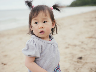 baby girl playing in the sandy beach,Northern Ireland