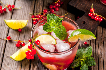 Ideas of summer drinks, dietary healthy cocktails. Mojito from lime, mint and red currant. On the...