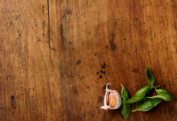 Cooking background with garlic, basil leaves. Top view.