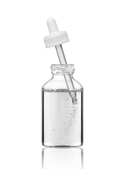 Pipette in a cosmetic bottle with liquid and bubbles, isolated on white background