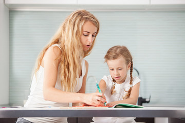 Parent teaches a child to write