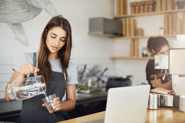 Female barista pouring water to better taste coffee nuances