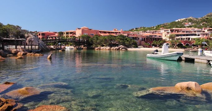 Coastline promenade with pine trees and yachts at Porto Cervo town. Porto Cervo is capital of Sardinia, Italy.