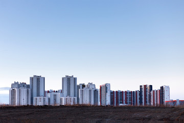 Modern cityscape, new building for people living on the sunset