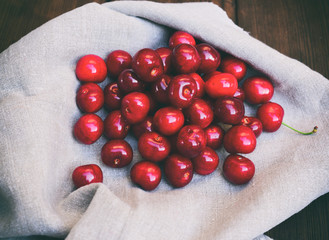 Ripe red cherry on a gray napkin