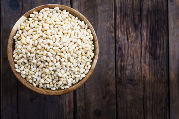 Shelled Raw Pine Nuts in the Wooden Bowl