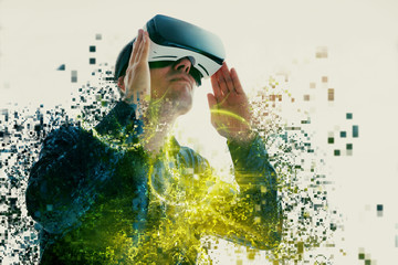 A person in virtual glasses flies to pixels. The man with glasses of virtual reality. Future...