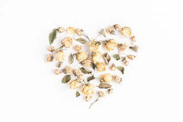 Autumn composition. Heart symbol made of dried autumn flowers and leaves. Top view, flat lay