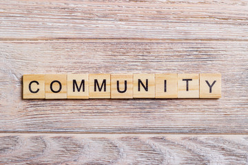 Community Word In Wooden Cube on a wooden background