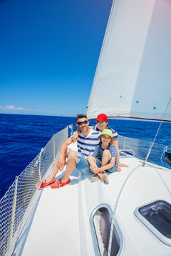 Family of three resting on yacht