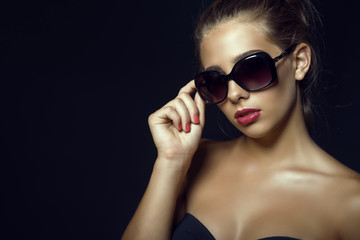 Close up portrait of young gorgeous glam tanned model with casual updo hair and beautiful make up...