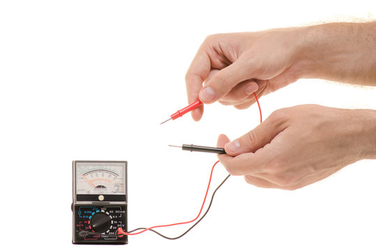 Multimeter analog in male hands isolated
