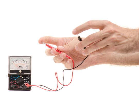 Multimeter analog in male hands isolated