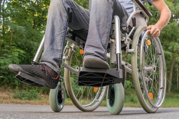 Naklejka premium Legs of handicapped or disabled man on wheelchair.