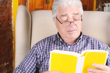 Old man reading a book.