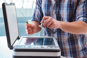 Repairman repairing broken color printer