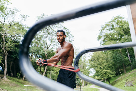 African man pulling expander