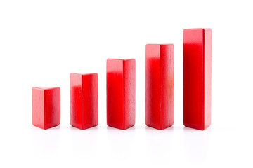 building a growing financial graph using red color wood toy isolated on white background, finance...