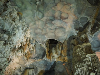 Gray stalactite stone cave ceiling