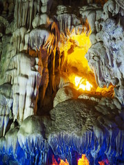 Grungy stalactite stone with yellow light up decoration hole background in the cave