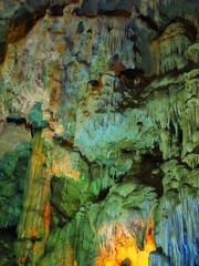 Stalactile stones in the cave with green light up decoration
