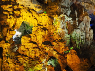 Grainy grungy stalactite stone with yellow light up decoration in the cave