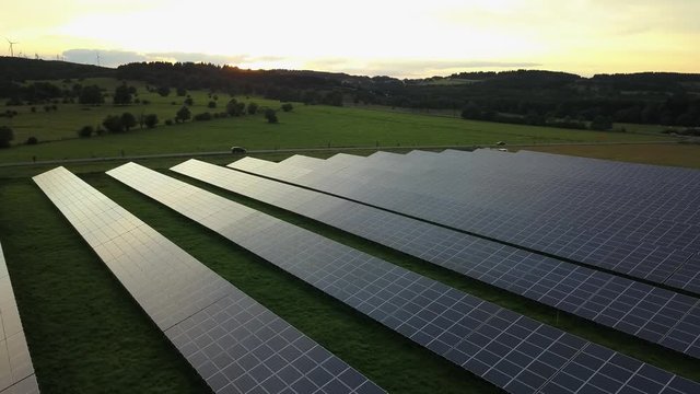 Aerial shot of photovoltaic solar panels at sunset 
