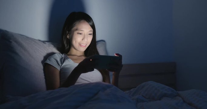 Woman enjoy playing game on smart phone
